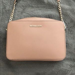 used MK crossbody purse. light scratch marks.